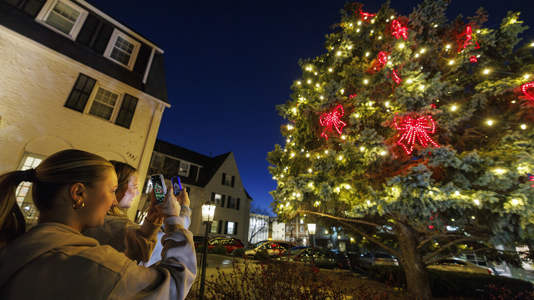 Alpha Phi members Jill Parr (left) and Kamryn Crouch frame up the evergreen decorated for the holidays on Dec. 7.