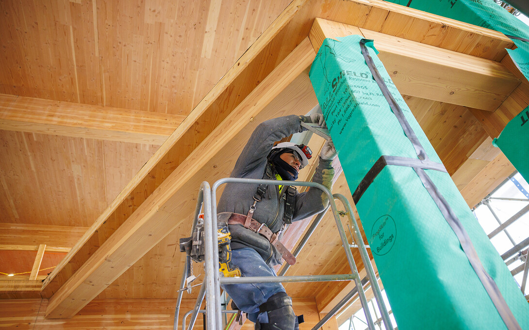 A construction worker works inside the new HDR Pavilion on the north side of Architecture Hall.