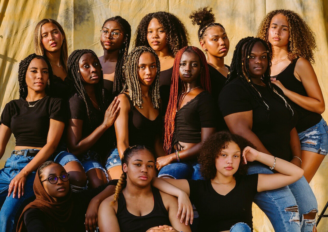 Posed photo of 13 young, Black women. Image is part of Funnah's BlackisBeautifulNE series.