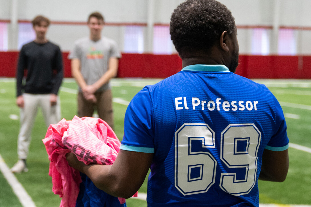 Professor Marcel Ngoko brings out the jerseys for the two teams at Cook Pavilion on Feb. 9, 2024.