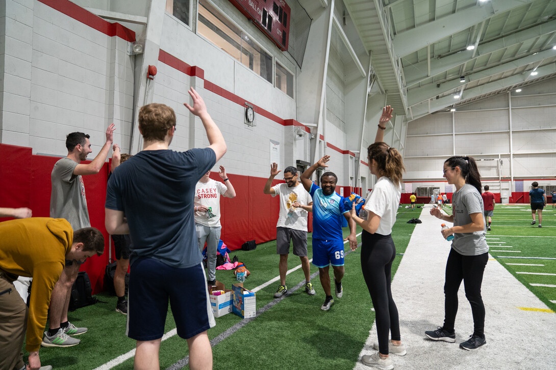 Professor Marcel Ngoko and his class break it down at the conclusion of their class bonding football game at Cook Pavilion on Feb. 9, 2024.