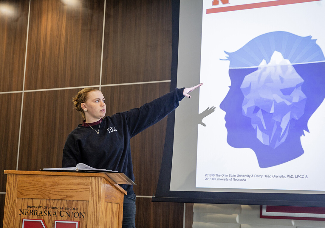 Madi Pfeiffer, a Big Red Resilience and Well-Being ambassador, goes over statistics about suicide for a REACH training session.