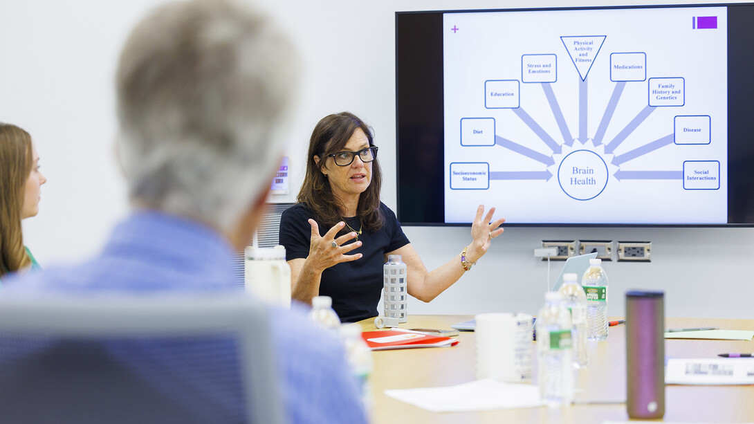 A group sits around a table during a meeting.