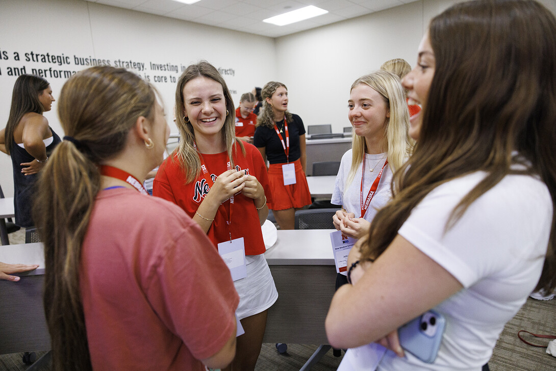 First-year students talk during a New Student Enrollment event in the College of Business' Hawks Hall.