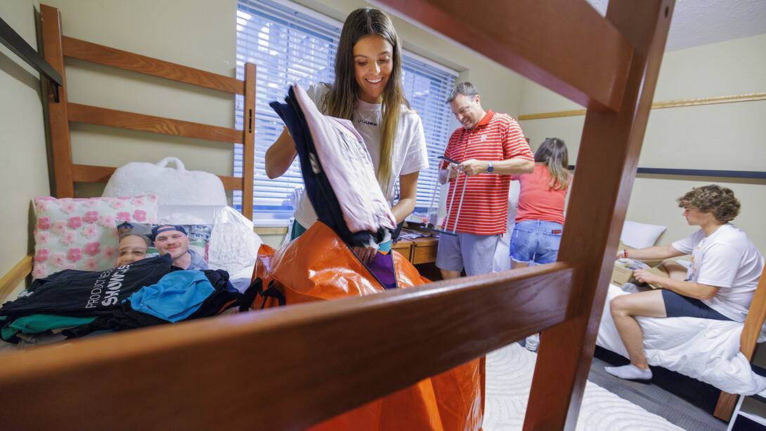 Abby Roberts of Elkhorn unpacks with her family after moving into a campus residence hall on Aug. 18..