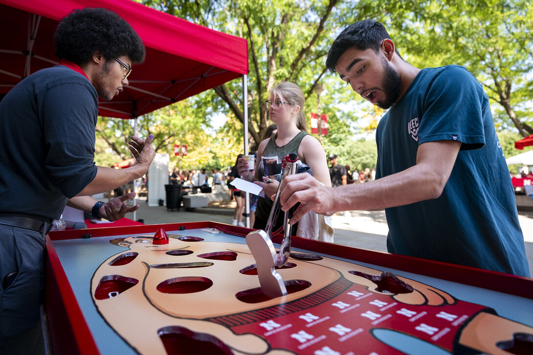 Damian Flores, right, reacts as he tries to pull and object out of a hole during a game of Operation.