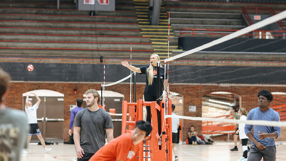 An official signals during an intramural volleyball game.