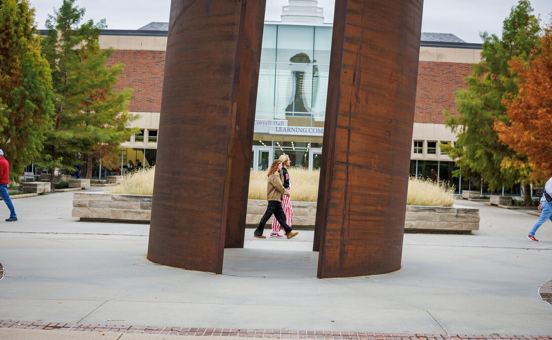 Fans walk through campus, in front of the Adele Hall Learning Commons.