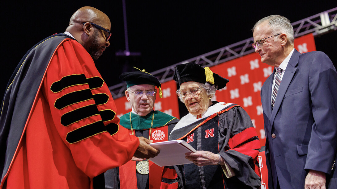 Chancellor Rodney Bennett hands Marion Larmon her honorary Doctor of Fine Arts degree. 