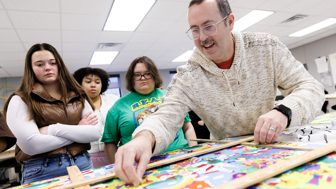 Michael Burton, assistant professor of textiles, merchandising, and fashion design, guides students in identifying patterns during the semester-opening session of his Advanced Design for Printed Textiles course on Jan. 22 in the Gwendolyn A. Newkirk Human Sciences Building.