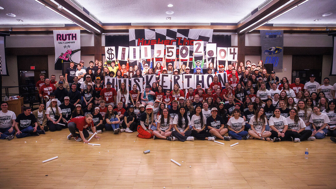 HuskerThon participants pose for a group photo to reveal that they raised more than $111,000 to support Children's Nebraska in Omaha.