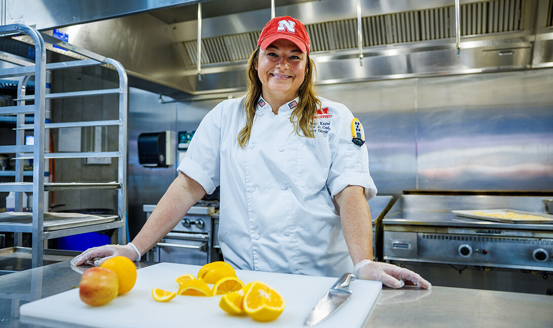 Paige Knebel stands in an industrial kitchen