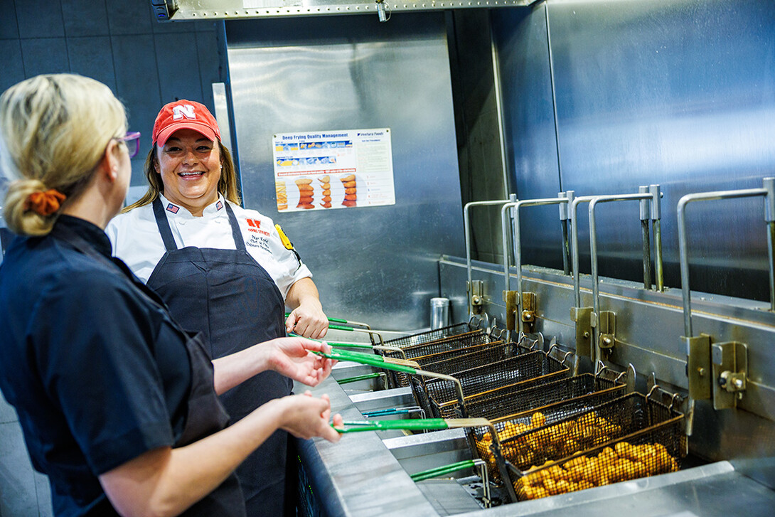 Paige Knebel works a fryer in the dining hall kitchen.