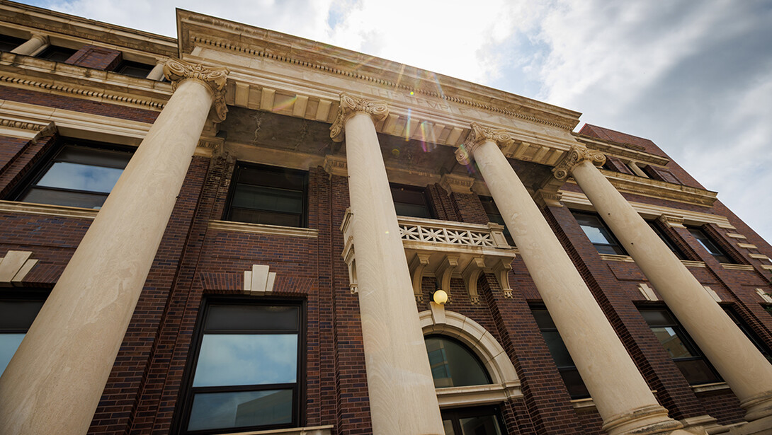 The Temple Building's columns jut out in front of the brick building.