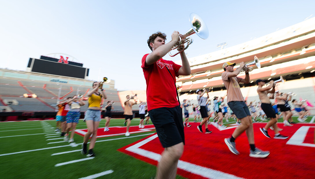 Eli Schuster, a senior mellophone player, marches during a warm-up exercise on August 18. Schuster is studying nutrition, exercise and health science.