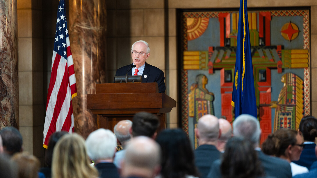 NU President Jeffrey P. Gold, M.D. standing at a podium in the Nebraska State Capitol.