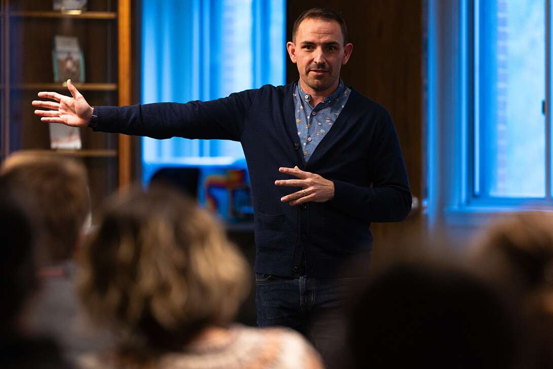 Kevin McMullen, research associate professor of English, gestures while speaking about the novel, "Fidelity," by Susan Glaspell. 