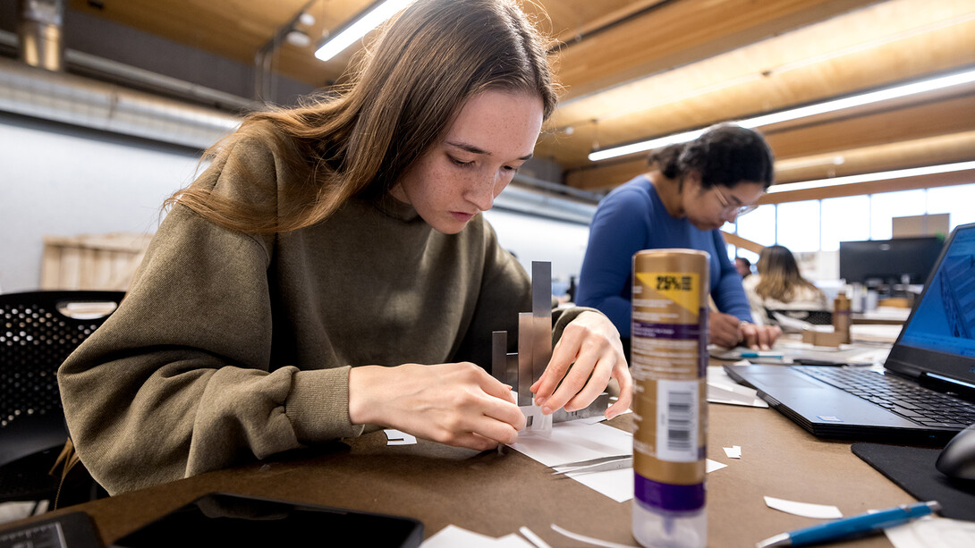 Taylor Yakel, a graduate student in architecture, works on building her model showing the work she has done to the Lincoln YWCA building inside Architecture Hall. 