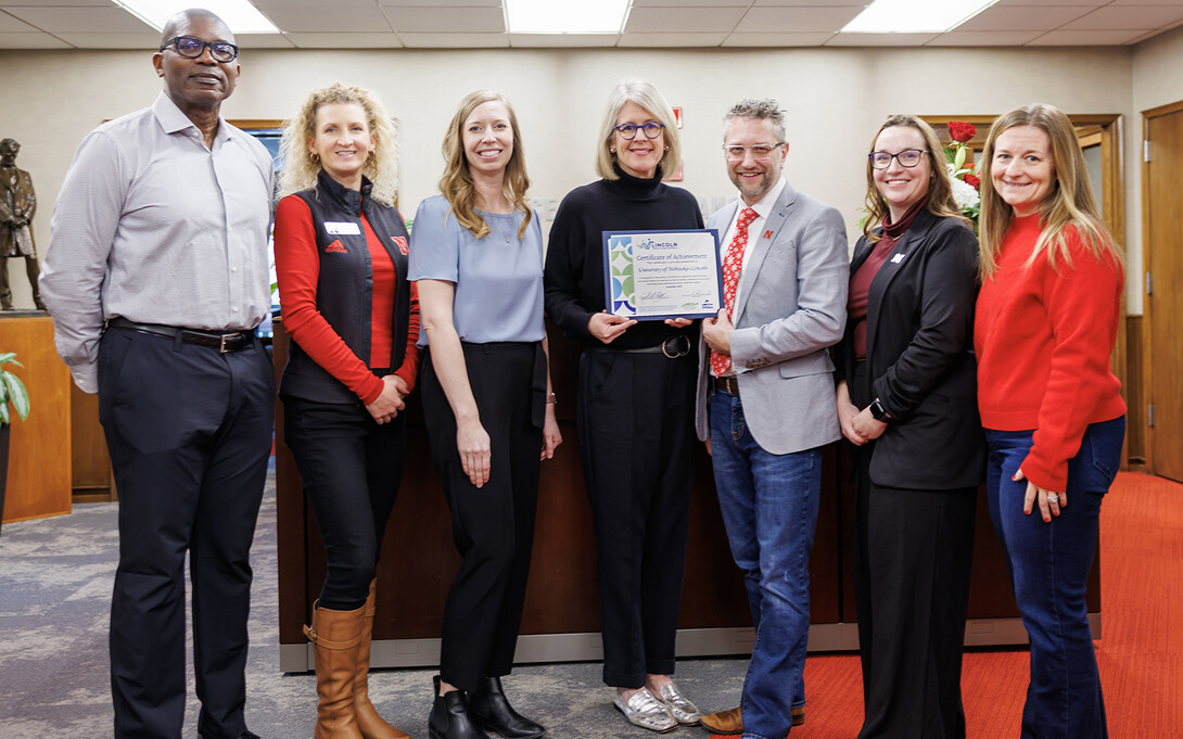 Allison Hatch (third from left), of the Lincoln Partnership for Economic Development, and Anne Brandt (fourth from left), of Lincoln Littles, presents the Lincoln Family Friendly Workplace certificate to UNL's (from left) Layton Brooks, Celeste Spier, Ben Lennander, Annalisa Davenport and Nicole Adkins.