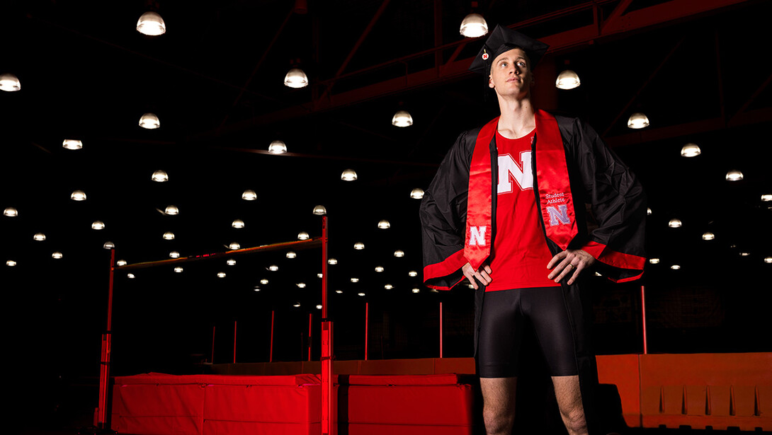 Tyus Wilson, a senior graduating with a degree in elementary education and high-jumper for the Husker Track and Field team, poses for a portrait inside the Devaney Center Indoor Track. 