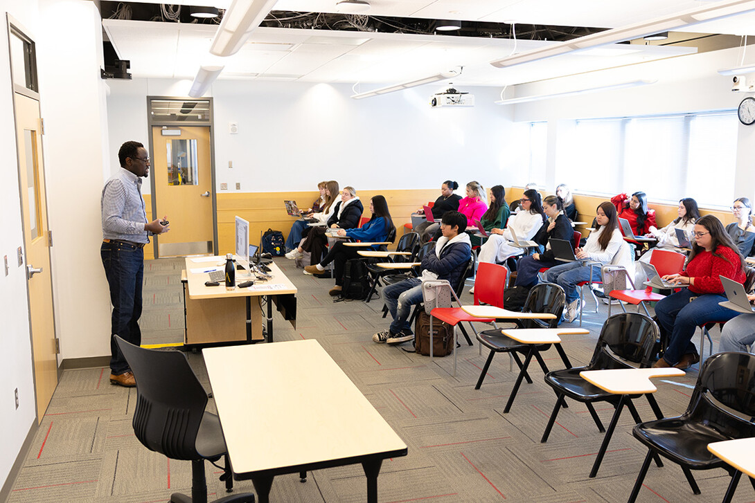 Dane Kiambi, associate professor of advertising and public relations, lectures during a morning class in Andersen Hall.