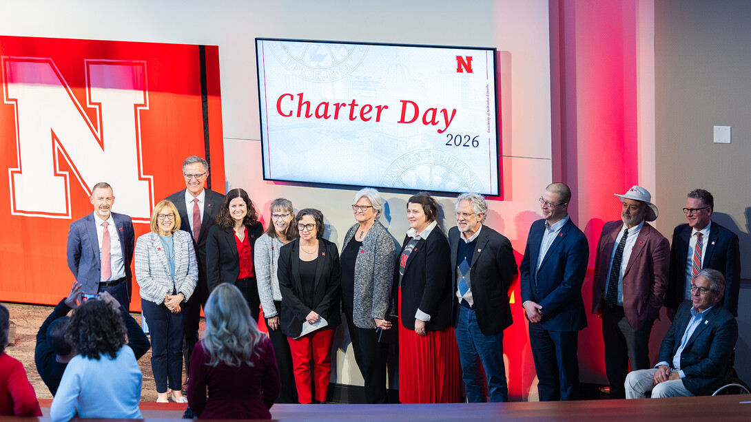 University of Nebraska–Lincoln deans, vice chancellors and Interim Chancellor Katherine Ankerson pose at the front of the lecture hall in the Nebraska Innovation Campus conference center after sharing their "why" during the university's Charter Day celebration.