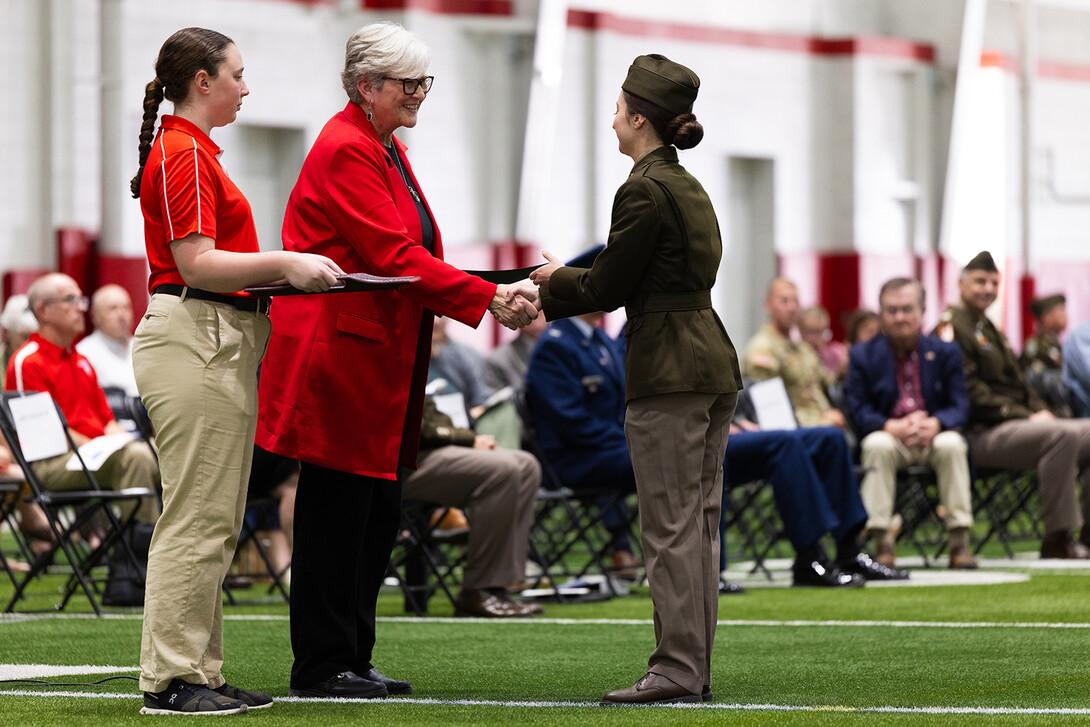 Interim Chancellor Katherine S. Ankerson presents the Chancellor’s Academic Excellence Award to Cadet Emily Augustin during the Joint Services Chancellor’s Review at the University of Nebraska–Lincoln.