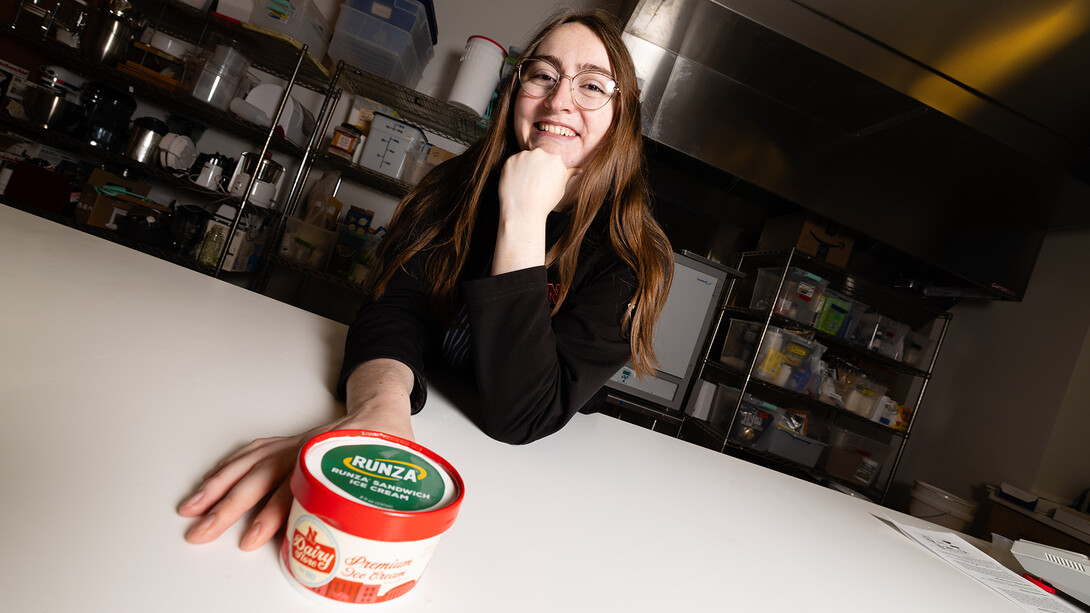 April Johnson, a product development project manager at the University of Nebraska–Lincoln Food Processing Center, holds a pint of Runza-flavored ice cream she helped develop — a limited-release treat that reimagines the iconic Nebraska sandwich as a sweet-and-savory frozen dessert.