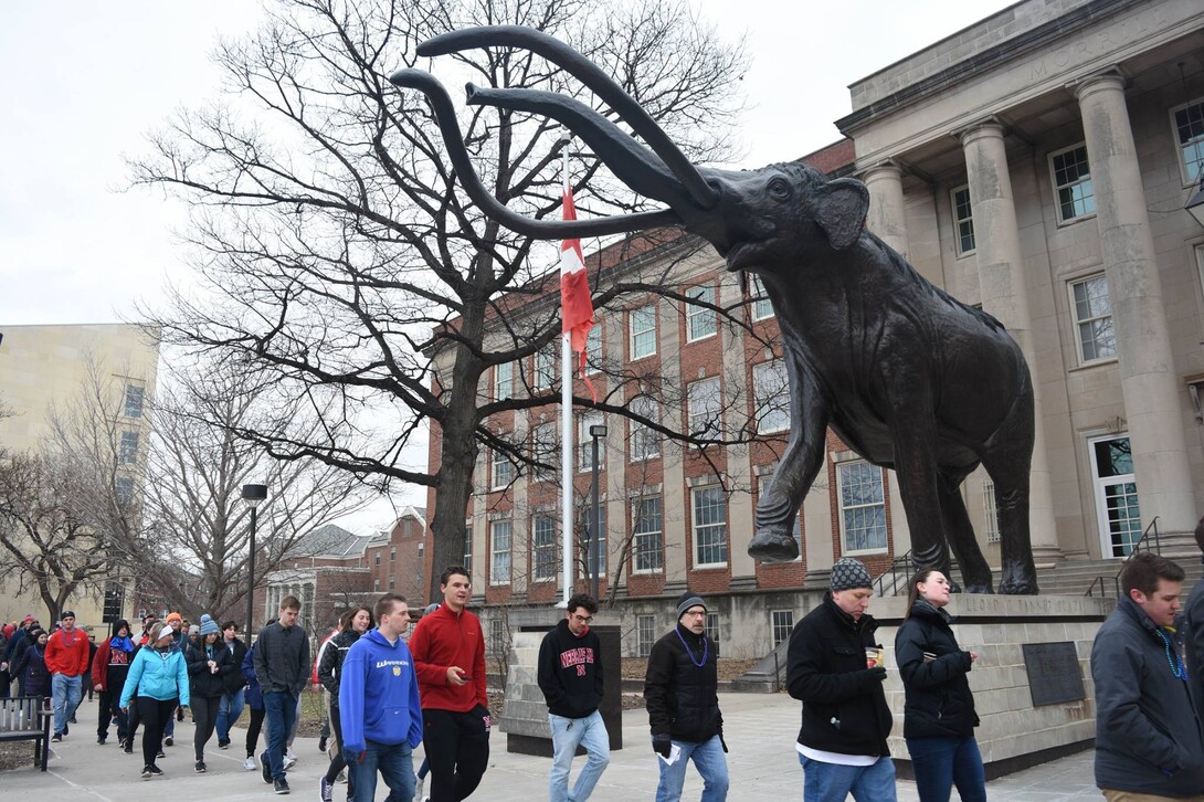 UNL Students walk by Morrill Hall during the 2018 Out of the Darkness Walk. Photo by Marcella Mercer.