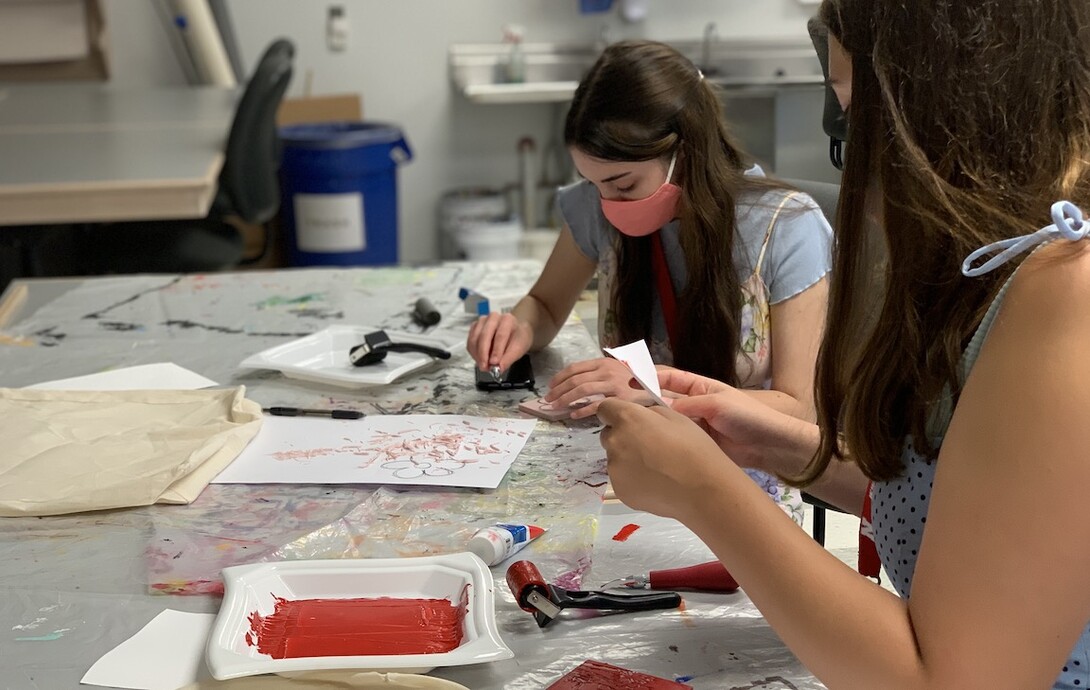 Participants make stenciled fabric designs.