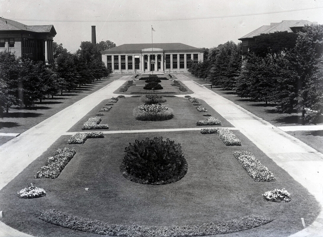 The East Campus Mall, looking north toward Chase Hall, featured flower beds in this image from the 1920s.