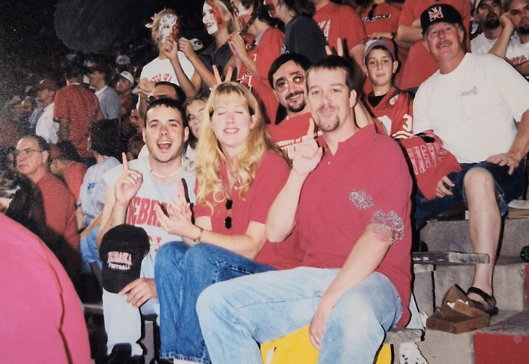 Mike Case poses with friends while at a Husker football game in the 1990s.
