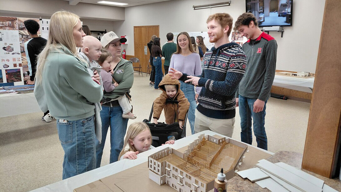 Students meet with Axtell residents in a conference room.