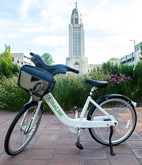 The BikeLNK service will feature three-speed cruisers with a basket and safety lights. The service will be available in April.