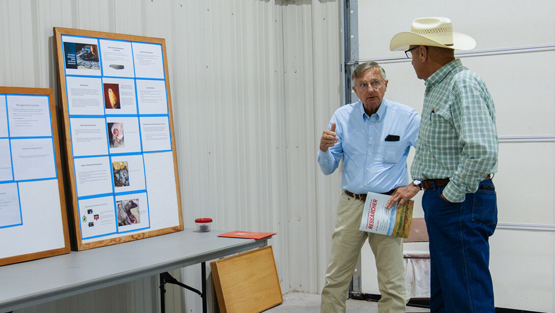 David Boxler (left) discusses fly control with a Nebraska rancher at the Gudmundsen Sandhills Laboratory Open House in Whitman, Neb. 