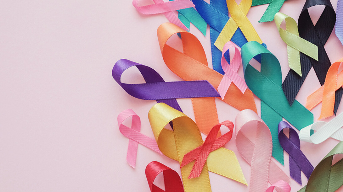 Various colors of cancer awareness ribbons are clumped together.