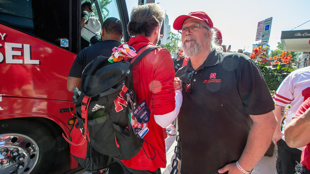 Mike Case wishes a member of the Husker football team well outside the Cornhusker Hotel before the Michigan State football game.
