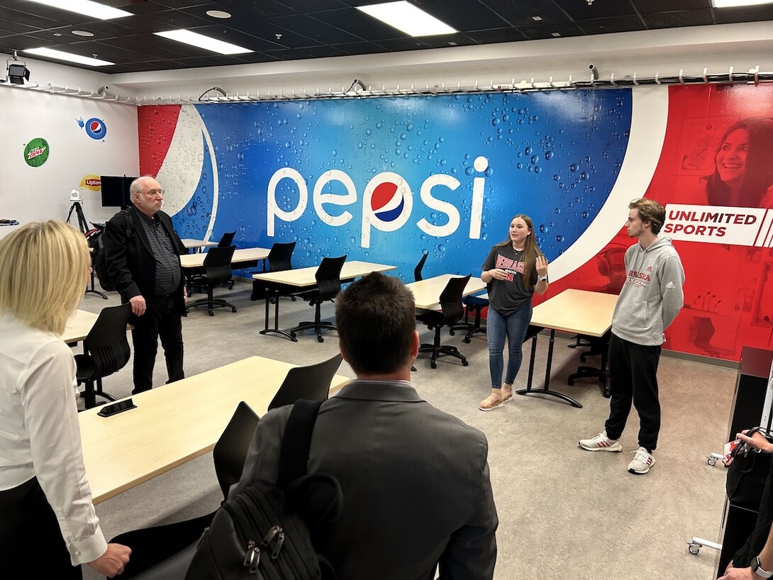 Krysten Collins speaks with visitors to the experience laboratory. 