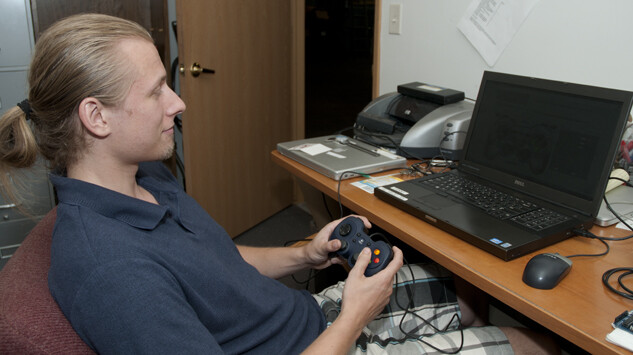 Justin Burnett, a graduate research assistant, programs an X-Box controller which will be used to fly the Deep-SCINI remotely operated underwater vehicle.