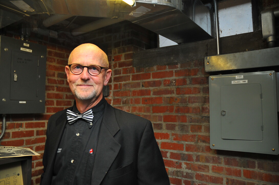 UNL's Jim DeCamp, manager of special projects, stands in the Andrews Hall room that contains the electronic carillon system that plays songs through Mueller Tower.