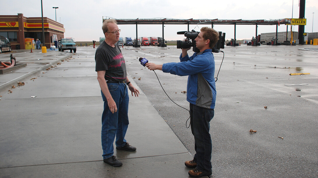 UNL's Ken Dewey (left) being interviewed at a truck stop following a 2008 storm in Nebraska. Dewey is a professor of climatology in the School of Natural Resources.