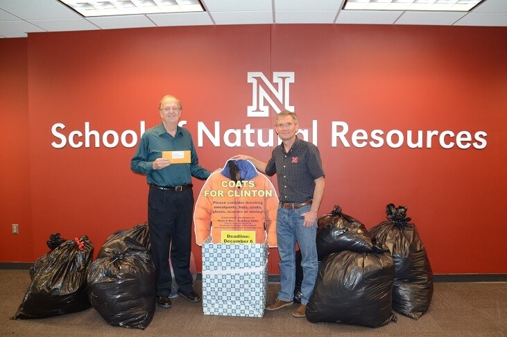 Ken Dewey (left) and SNR director John Carroll with the "Coats for Clinton" donations.