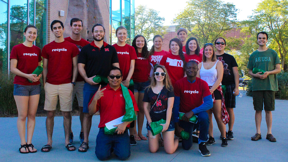 Go Green for Big Red volunteers pose for a photo during the 2018 season. Prabhakar Shrestha, the university's recycling coordinator, is pictured in the front row (kneeling), at left. 