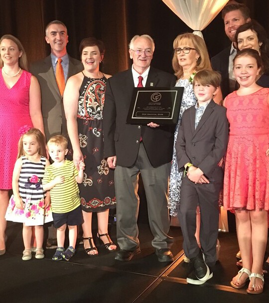 Surrounded by family, Dee Griffin (center) accepts the Industry Leadership Award from the Cattle Feeders' annual banquet.