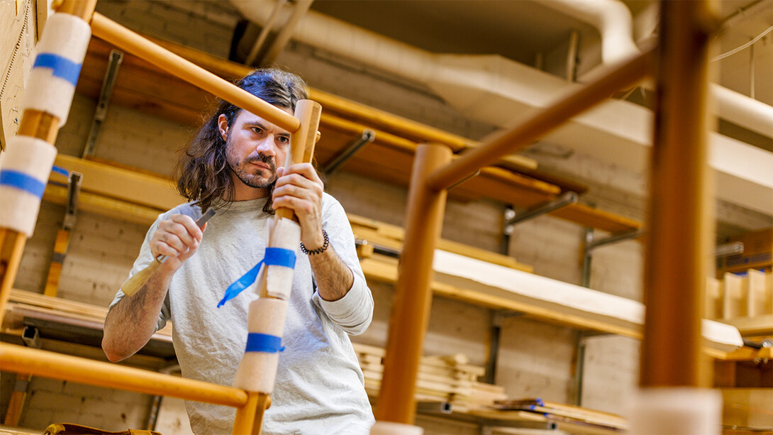 Joe Holmes working on a piece of furniture