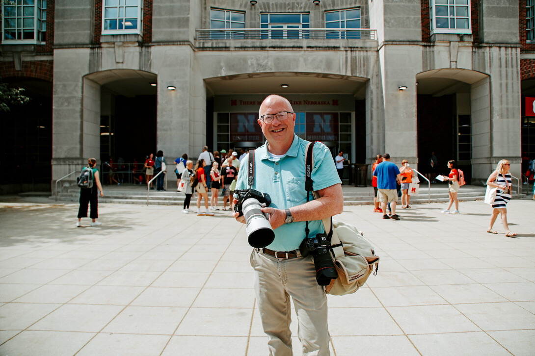 Chandler with his camera equipment, seen here photographing New Student Enrollment on city campus.