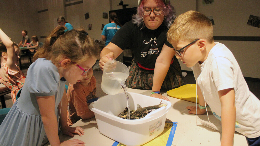 Youth watch a water experiment as part of the University of Nebraska State Museum's Discovery Day Camps.