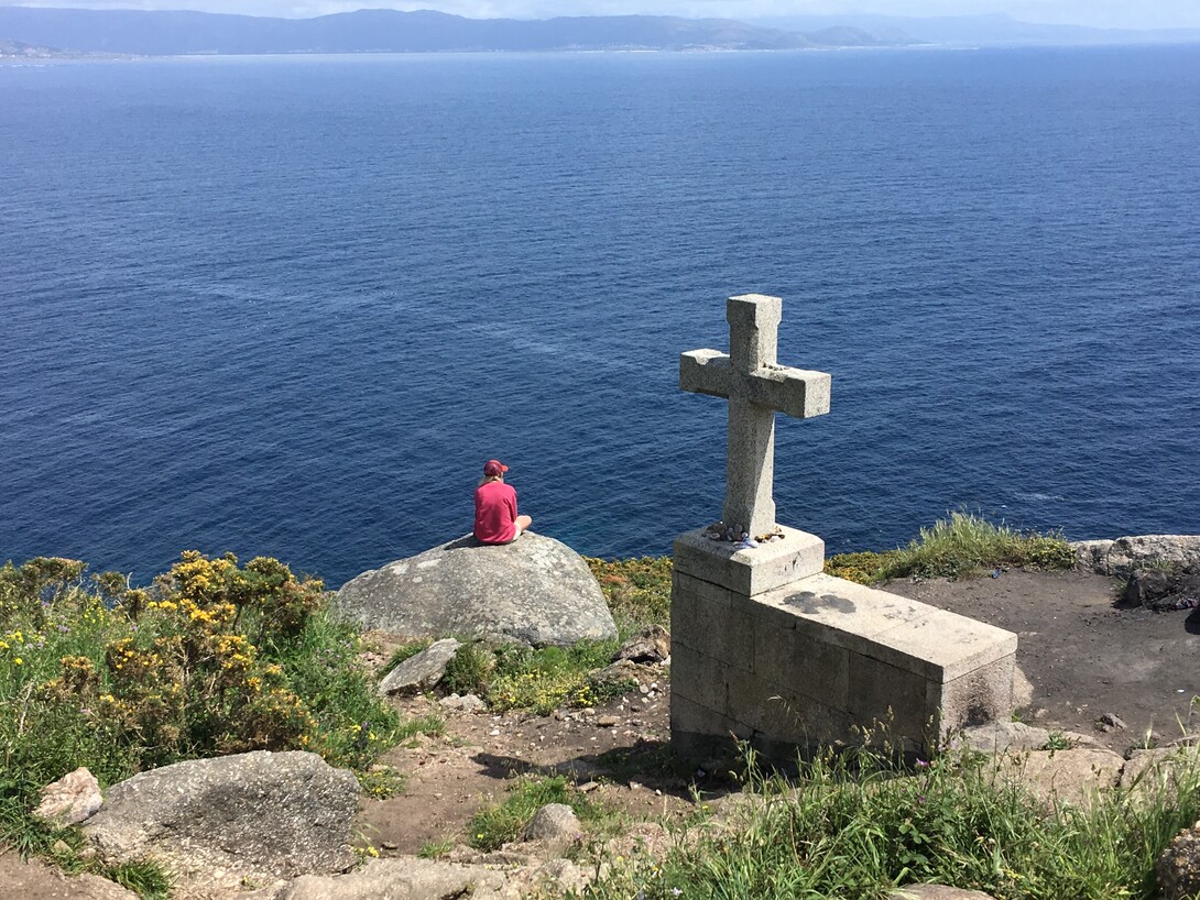 Nebraska's Tori Tyron looks out across the Atlantic Ocean at the end of the Camino de Santiago pilgrimage.