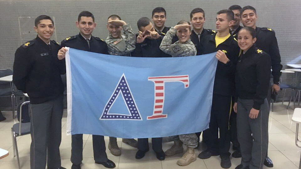 Nebraska's Molly Murphy and other cadets pose with a Delta Gamma flag. Murphy, along with being a fourth-generation member of the military and third-generation Husker, is also a third-generation member of the sorority.