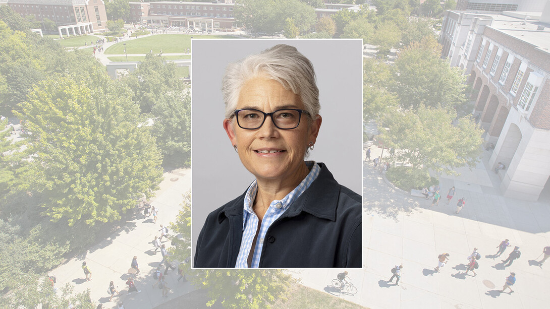 A portrait of Karen Becker is imposed on a background of green trees.
